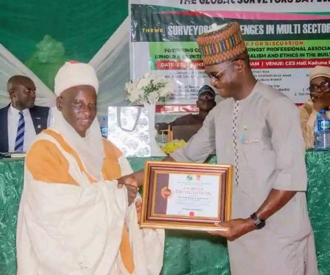 (L-R) Surveyor Iliyasu Abdulmumini Saeed, MINS, Sarkin Fadan Kajuru, receiving an award.